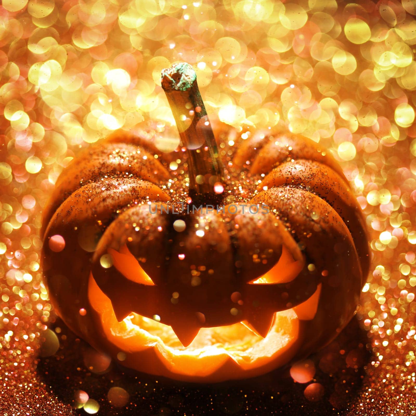 Glowing Jack-o-Lantern on sparkly orange background