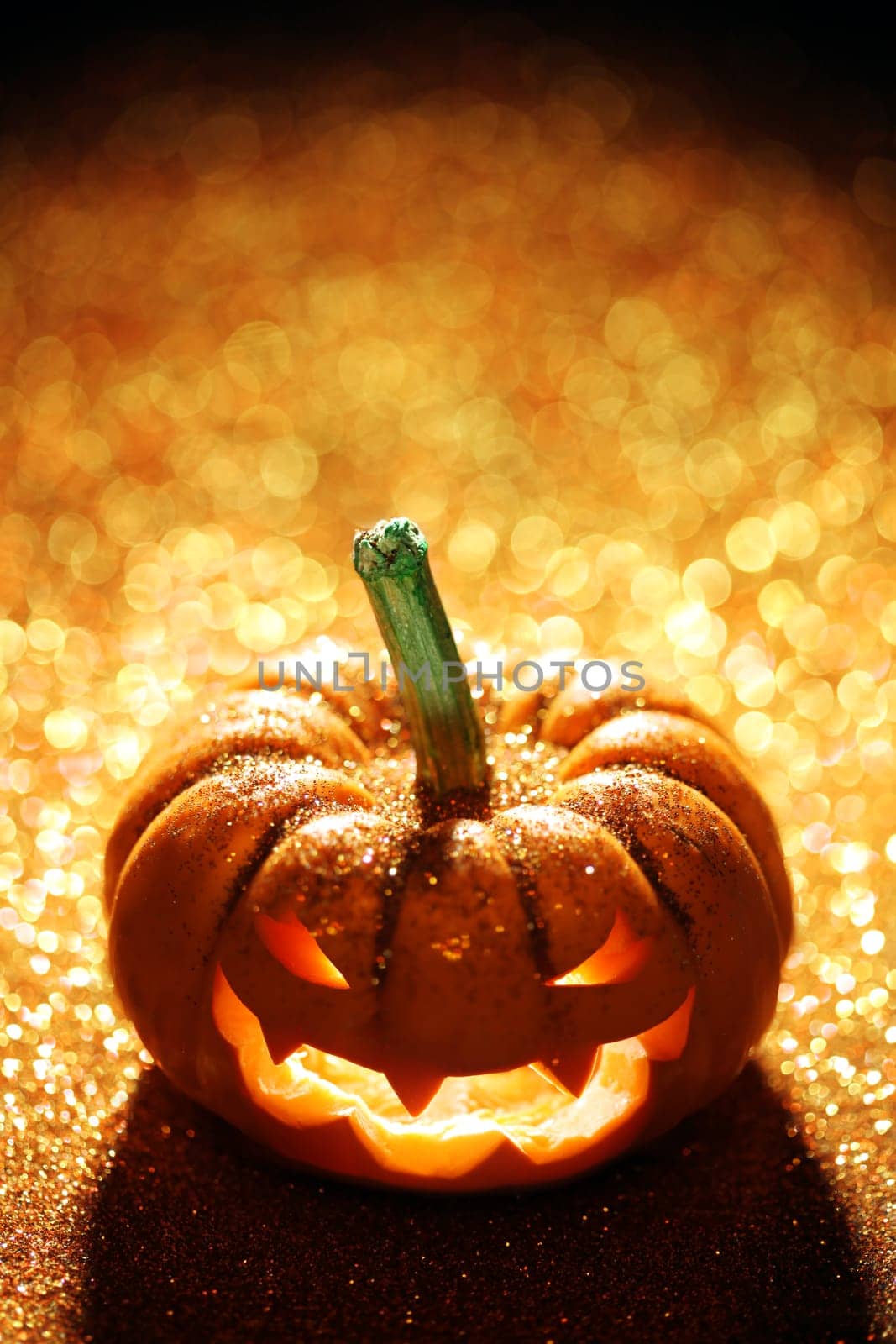 Glowing Jack-o-Lantern on sparkly orange background