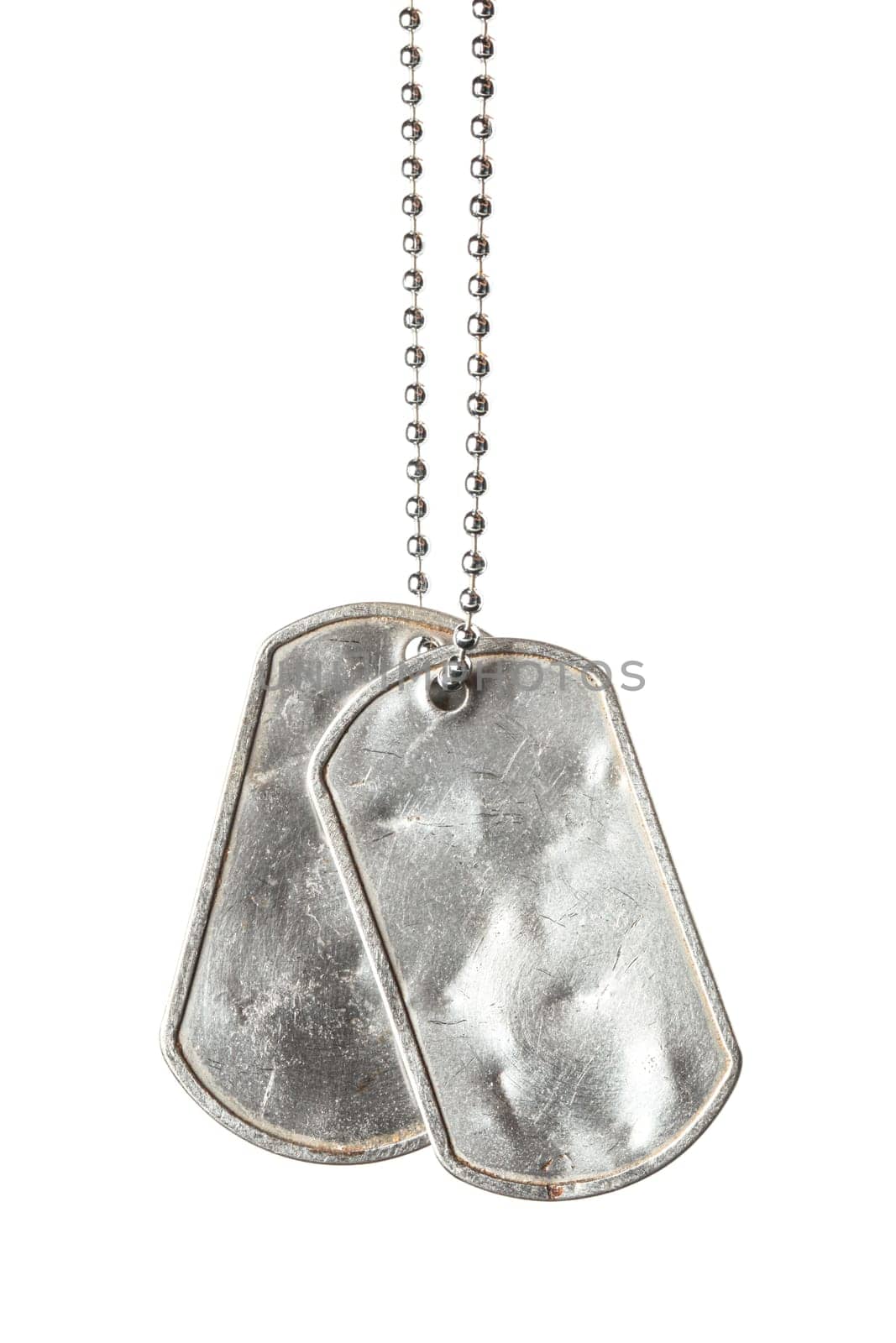 Old and worn blank military dog tags with chain isolated on white