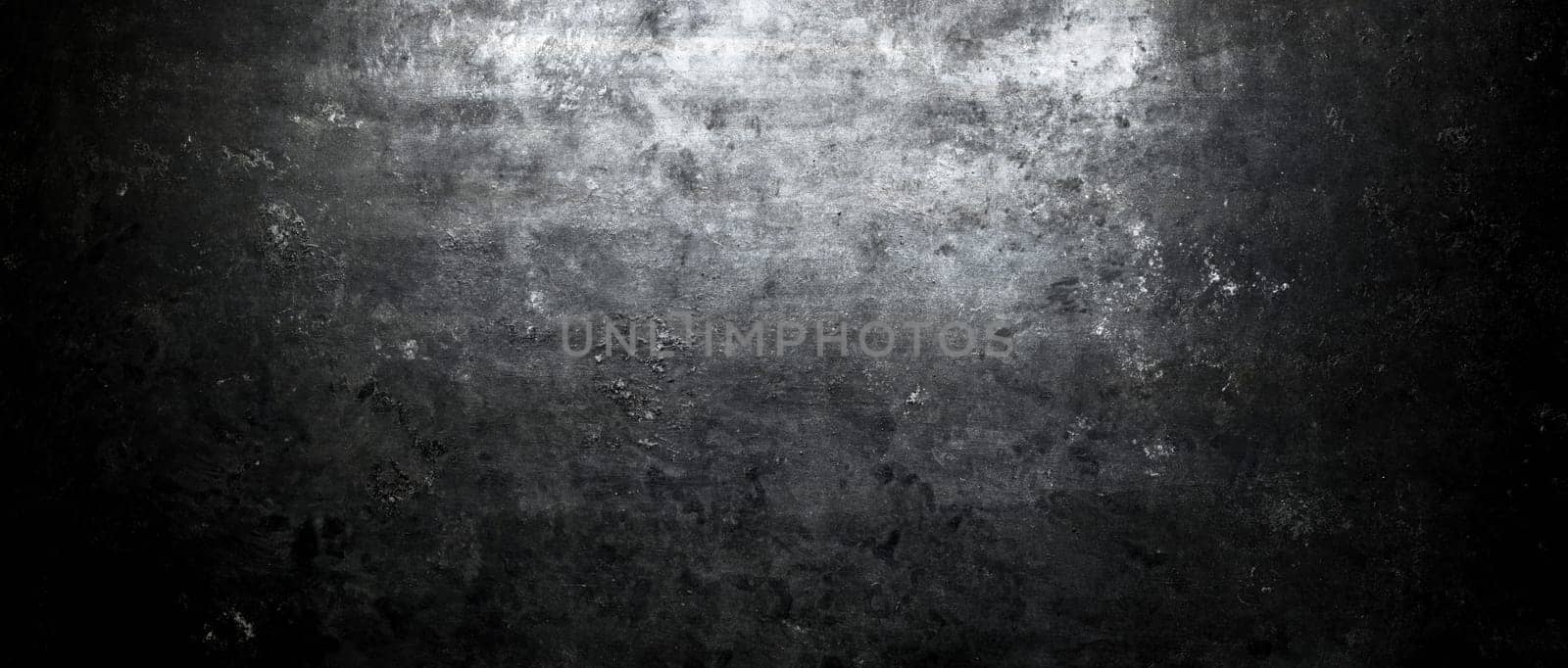 Rough, dark stone wall lit from above by spotlight. Grunge background
