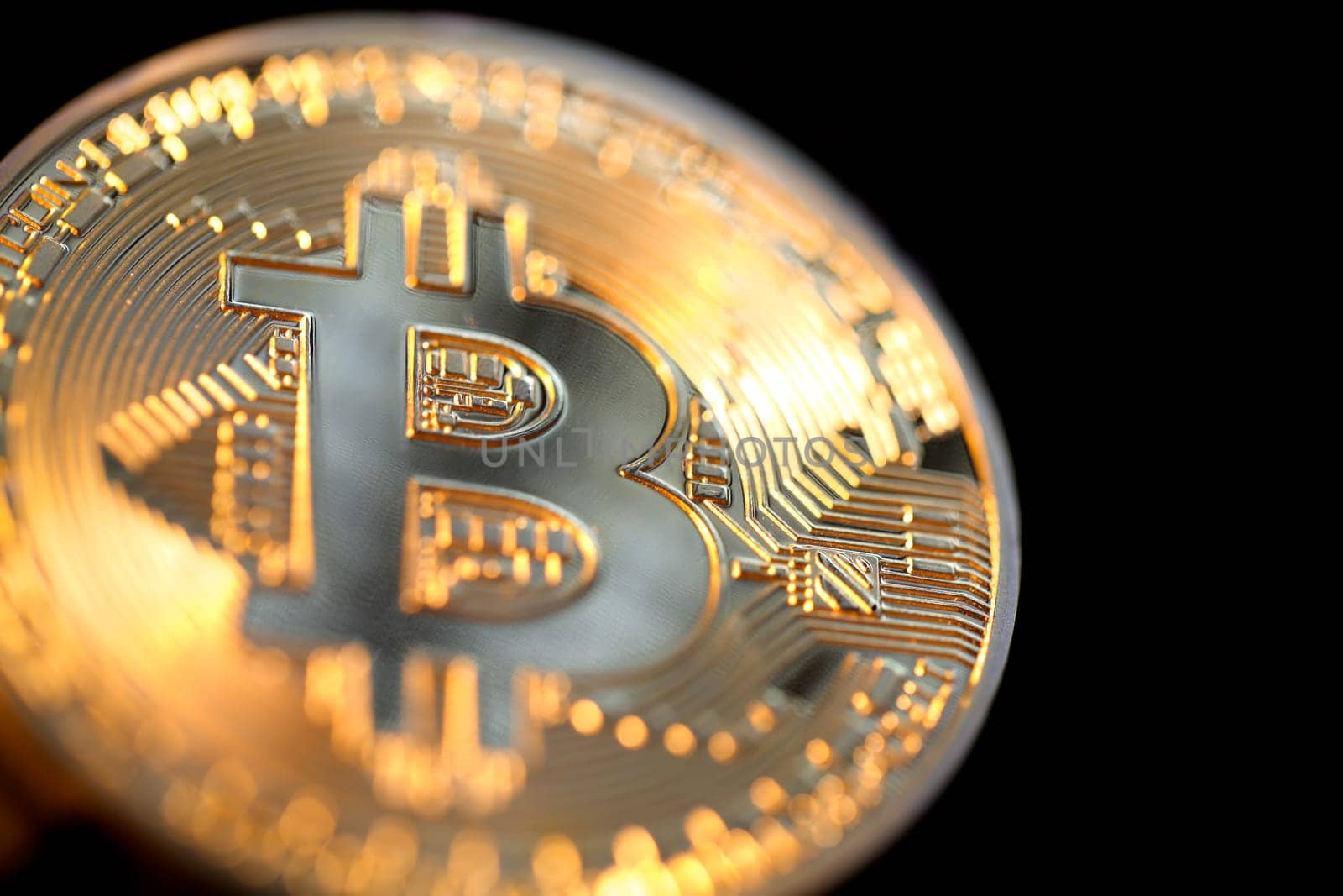 Close up of a single shiny bitcoin coin.  Wealth, digital, virtual, currency, and cryptocurrency concept.