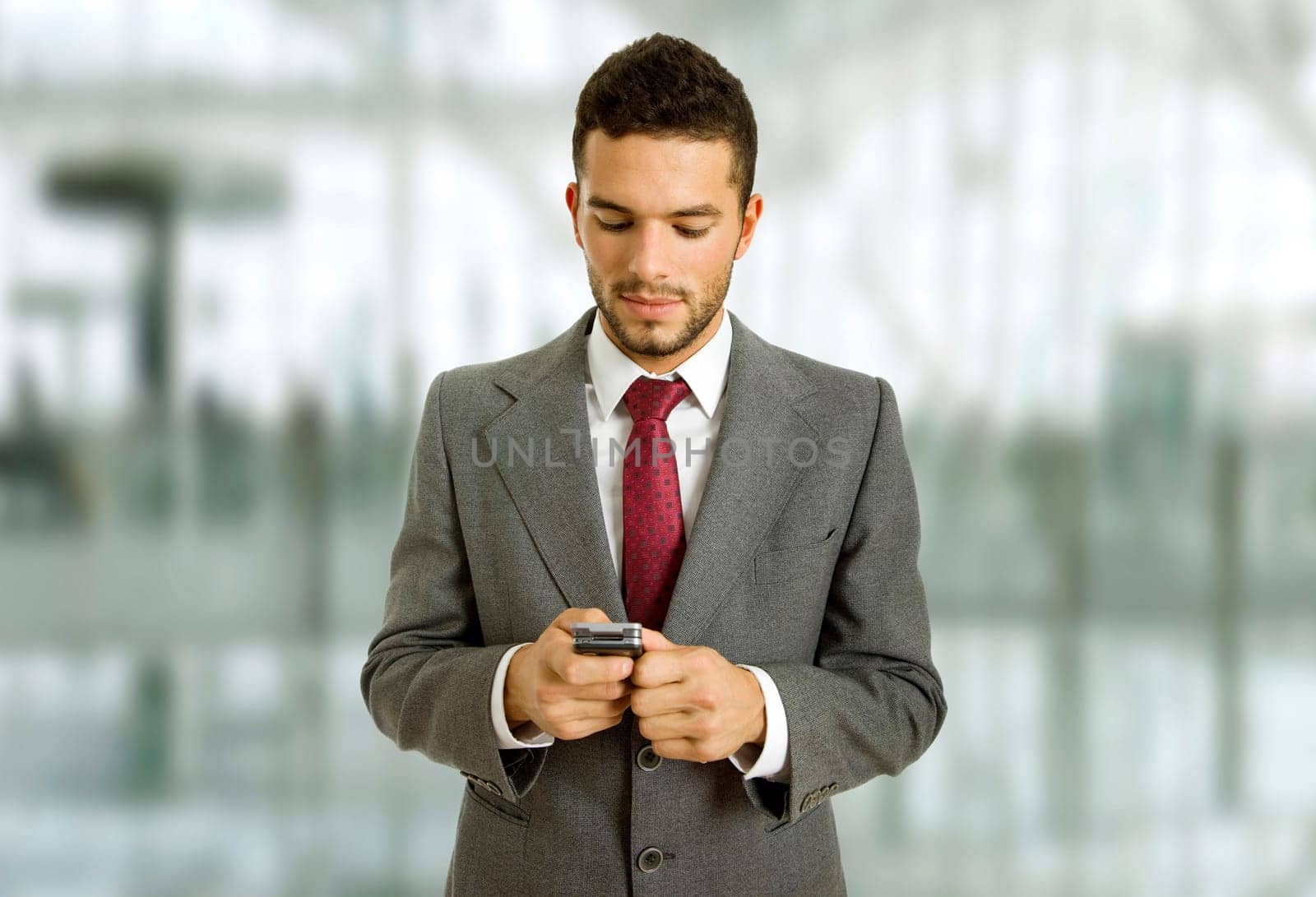 young business man looking to his phone