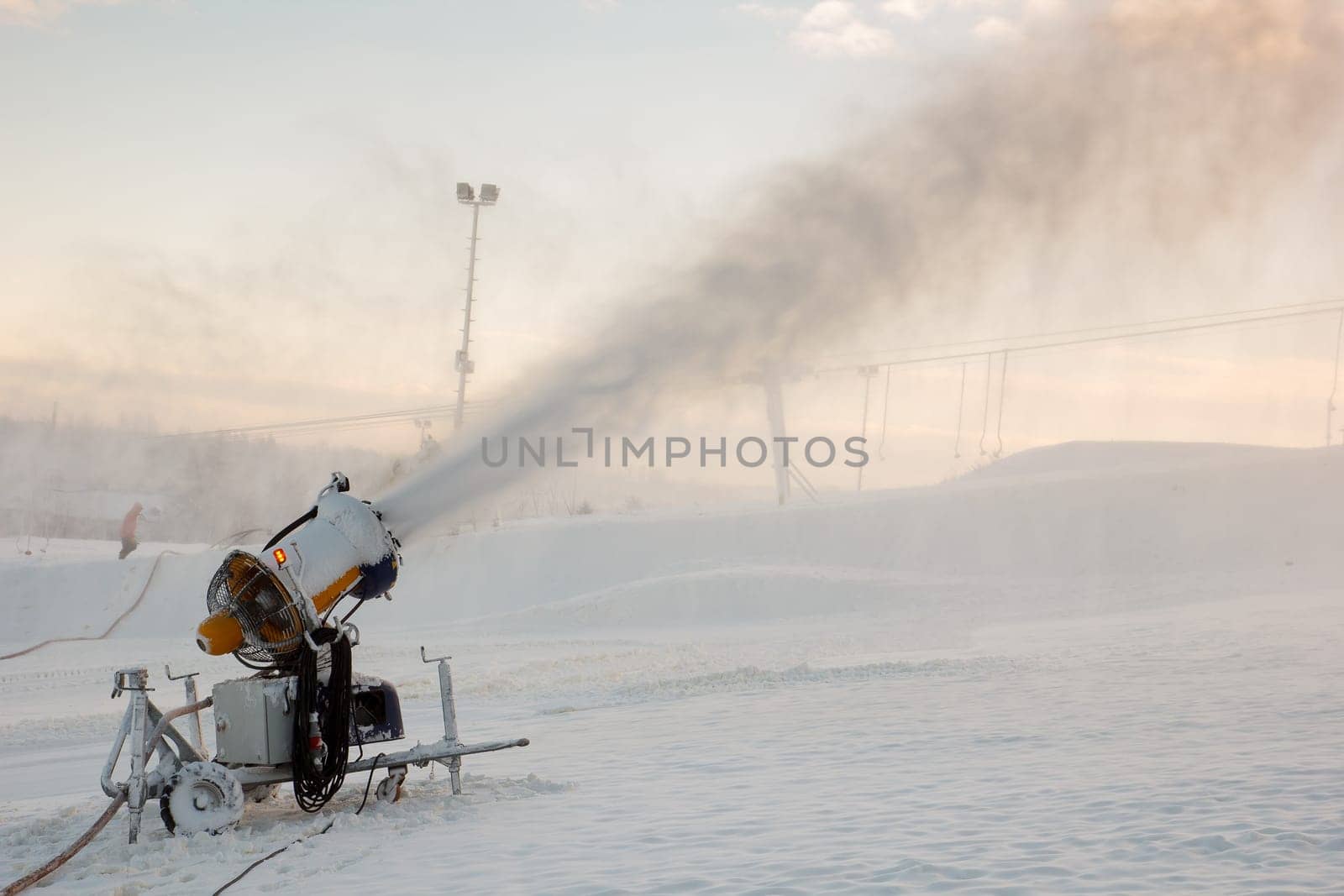 A snow blowing muchine being used to spray snow