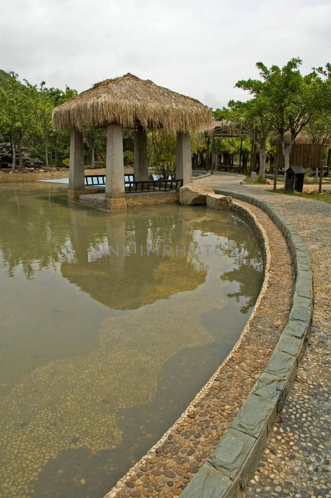 The pavilion with thatch roof beside swimming pool