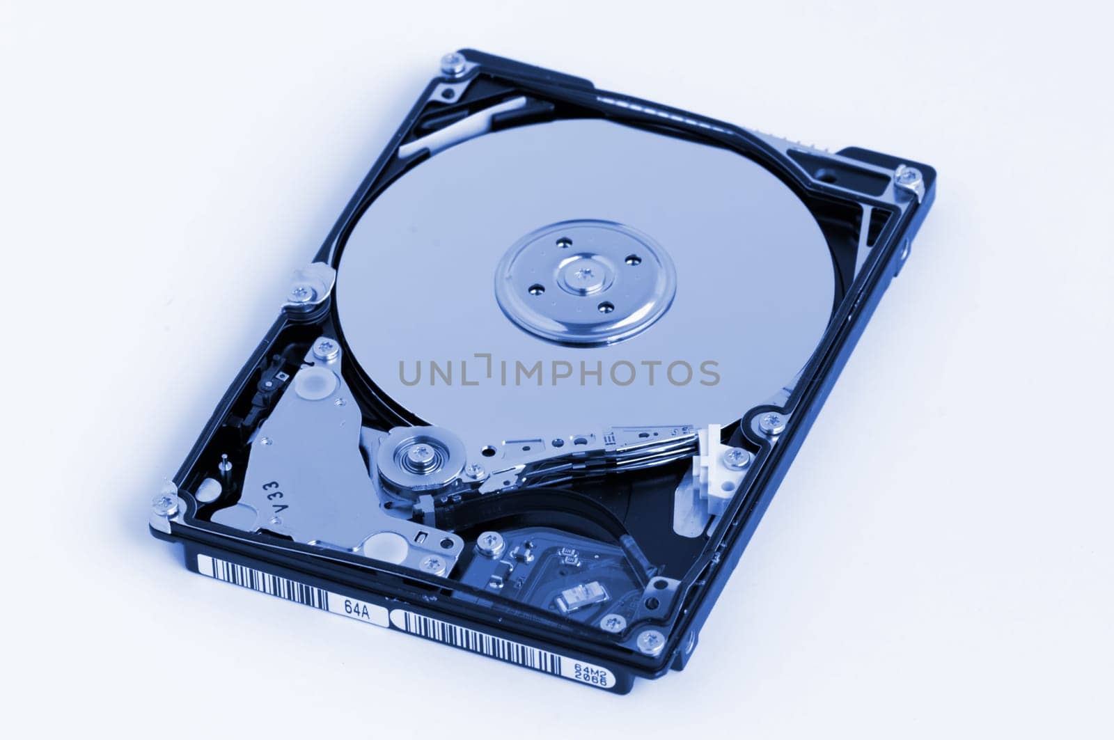Opened hard disk showing the disk surface and drive head