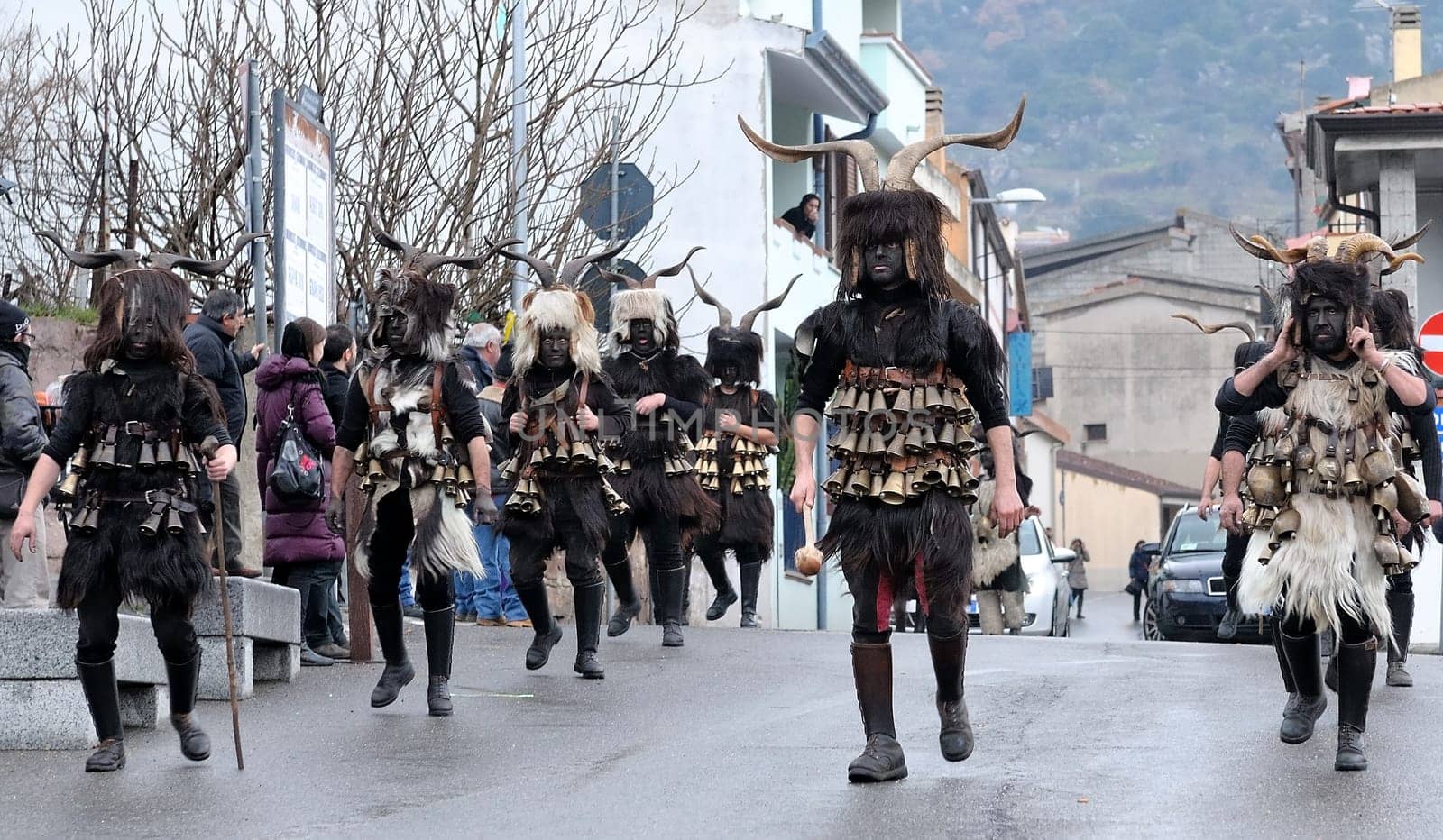 Orani, Sardinia, Italy - February 15, 2015: Parade of traditional masks of Sardinia during the Carnival 2015 in Orani.