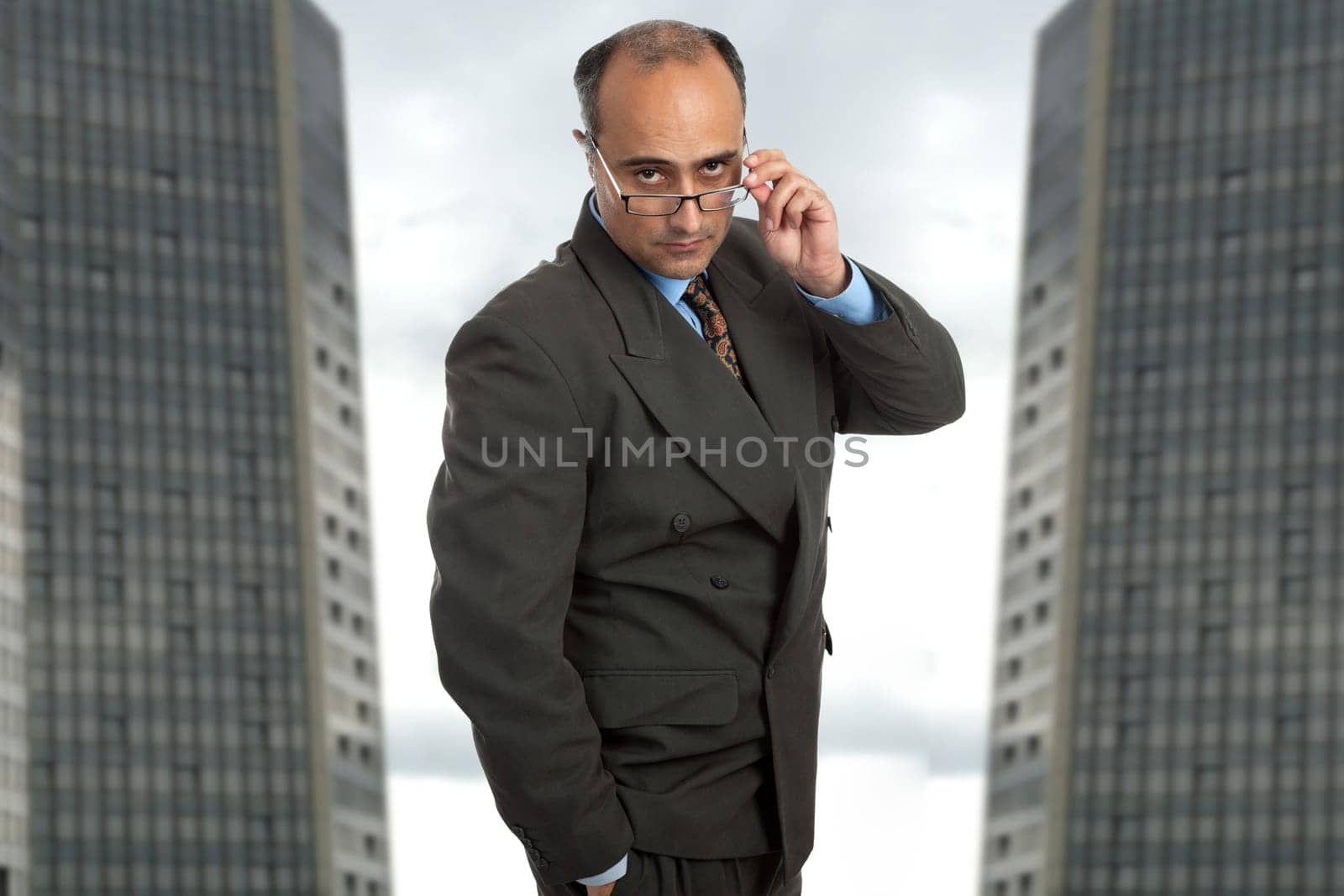 mature business man thinking taking off his glasses
