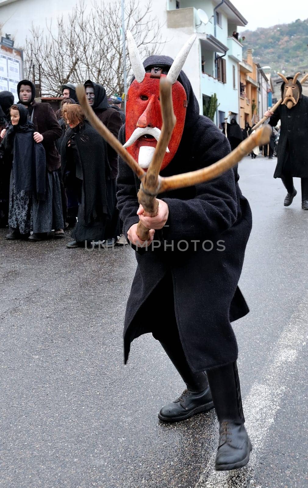 Orani, Sardinia, Italy - February 15, 2015: Parade of traditional masks of Sardinia during the Carnival 2015 in Orani.