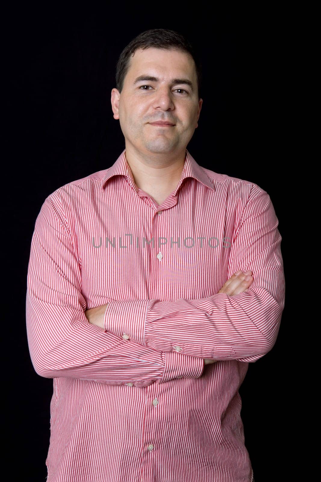 young casual man portrait on a black background