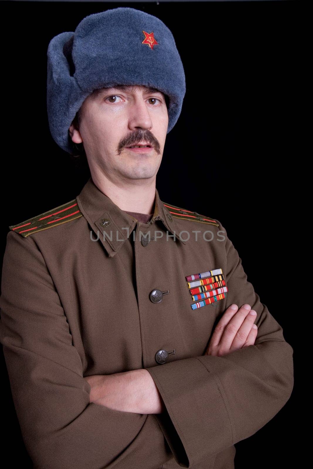 young man dressed as russian military, studio
