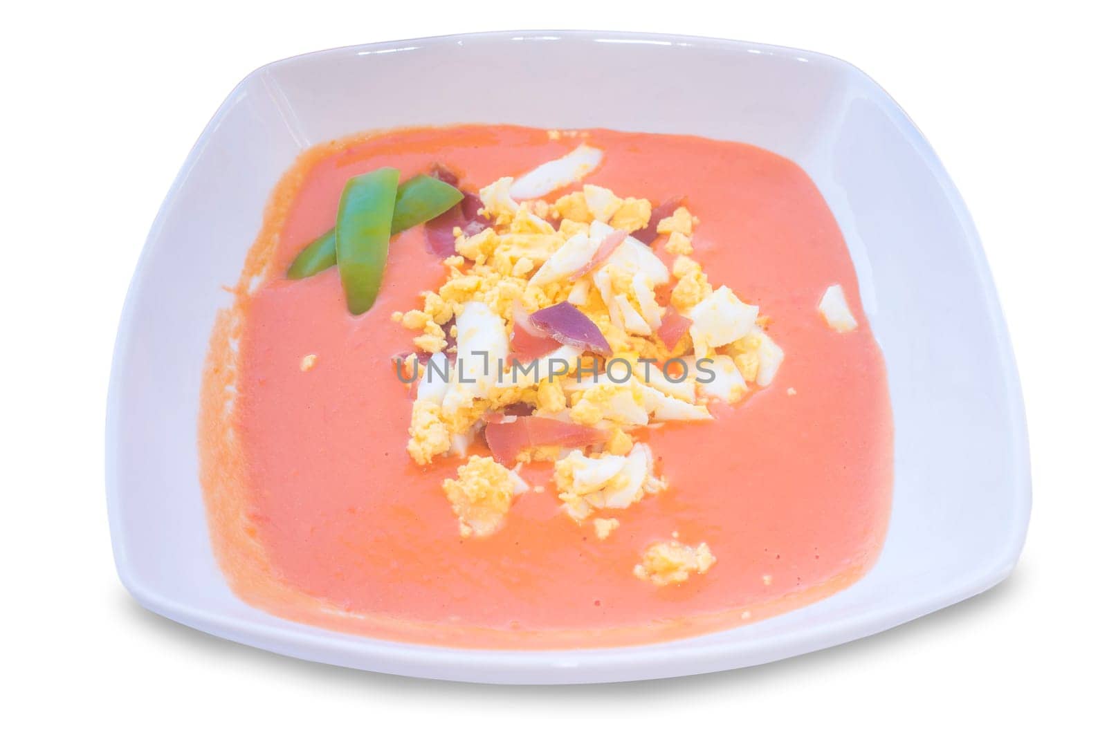Salmorejo saucepan topping decorated with green peppers. Isolated over white