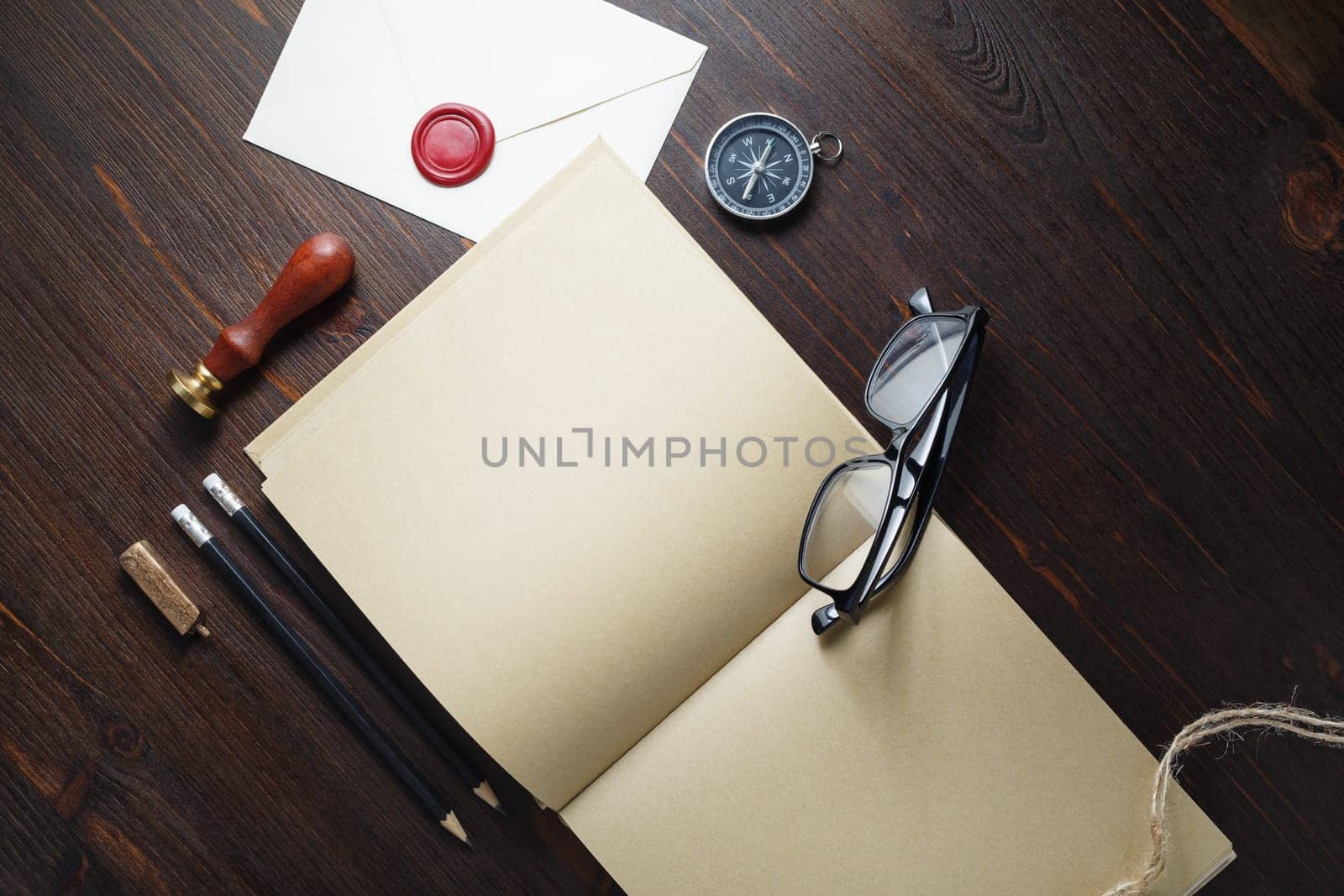Kraft paper book and retro stationery on wood table background. Branding mock up. Flat lay.