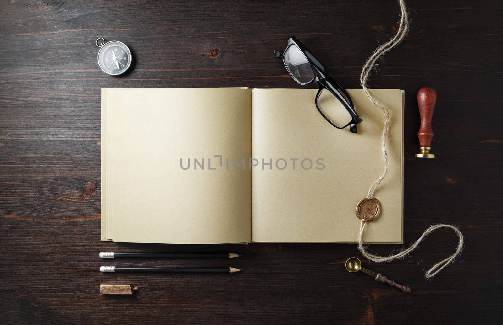 Blank kraft paper book and vintage stationery set on wooden background. Copy space for text. Flat lay.