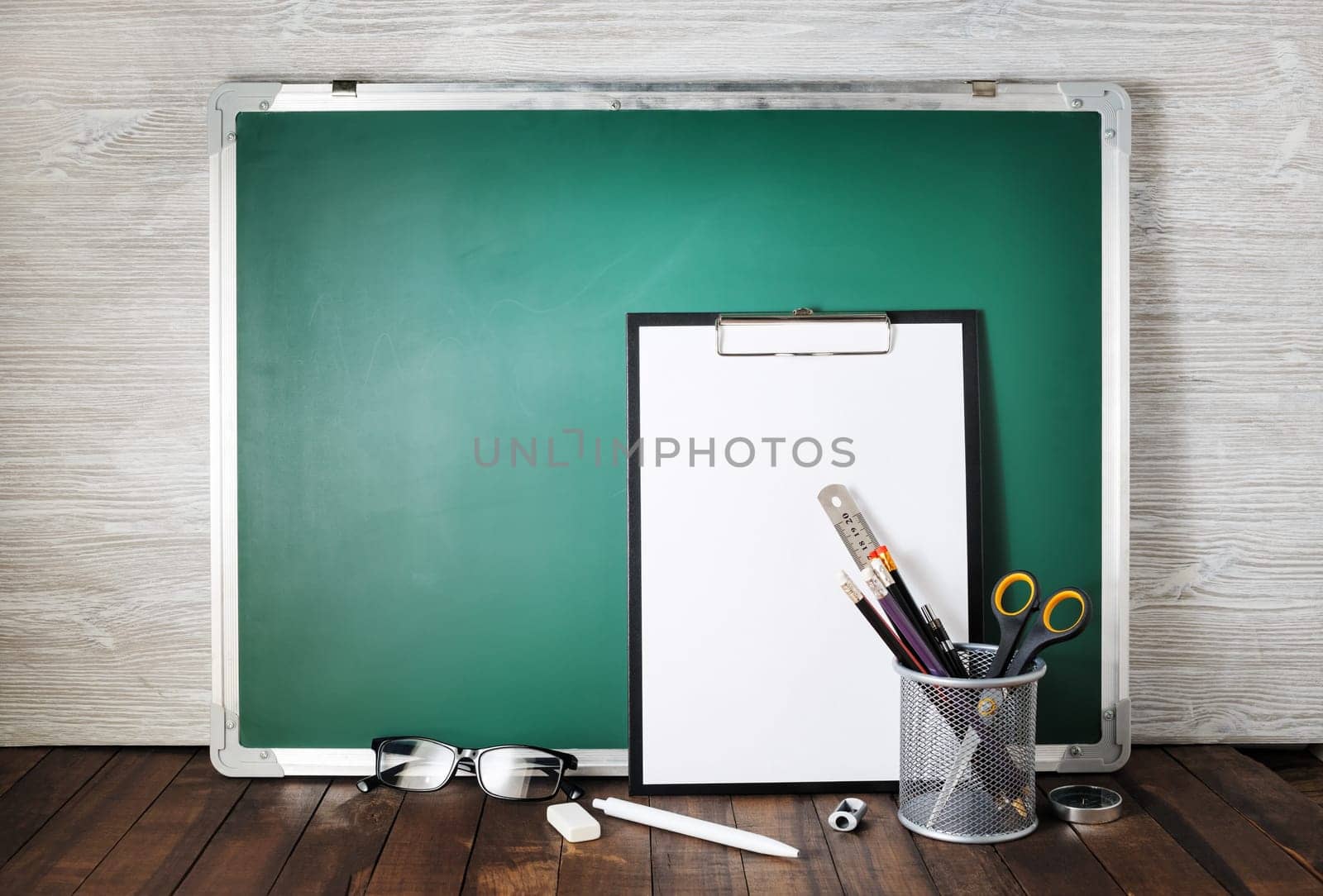 Photo of blank green blackboard and stationery. School supplies. Responsive design template.