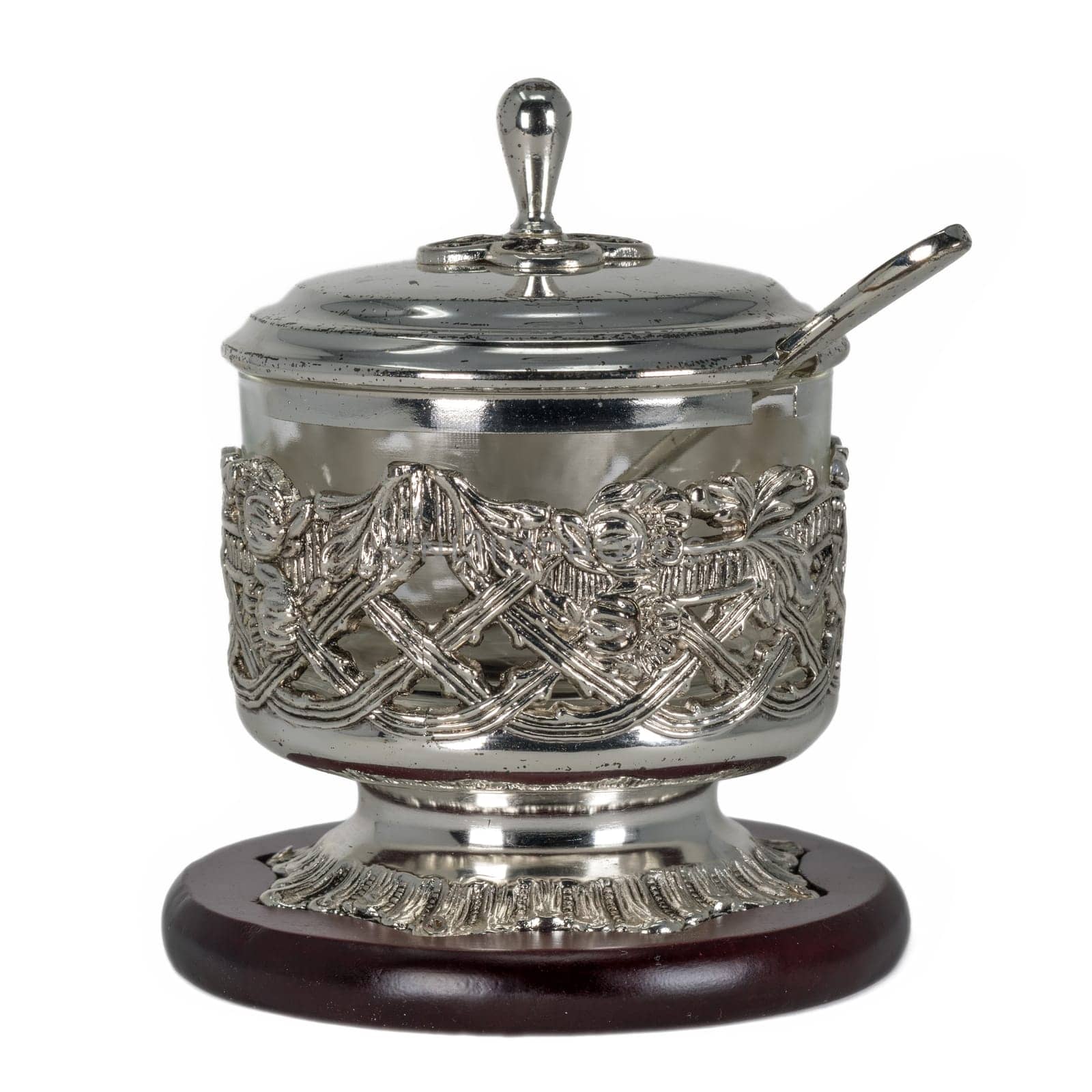 Sugar bowl of silver metal with glass insert and spoon. Isolated on white