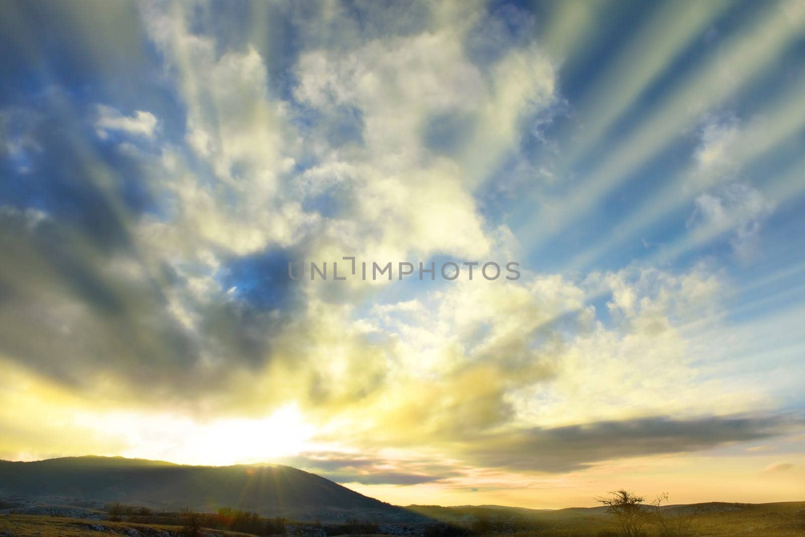 Sunset blue sky with sun and clouds
