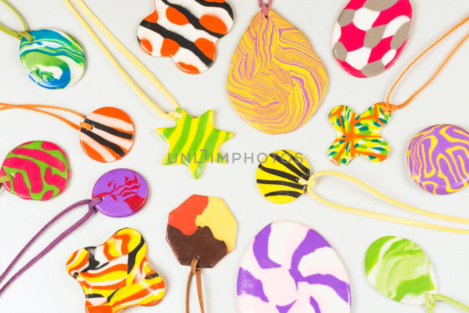 Colorful handmade trinket from modeling clay on white background, handicraft and creativity.