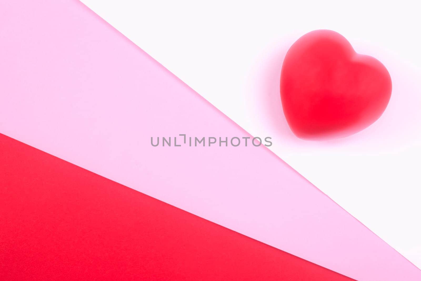 Red heart on white, pink and red background, symbol of love for Valentines day, minimalism.