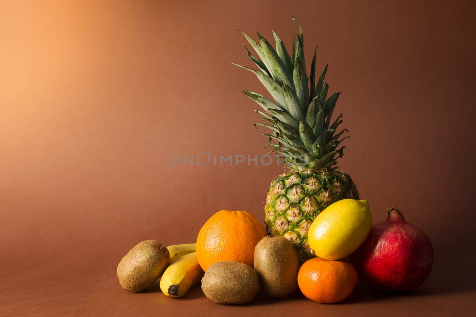 Different exotic tropical fruits are on brown background.