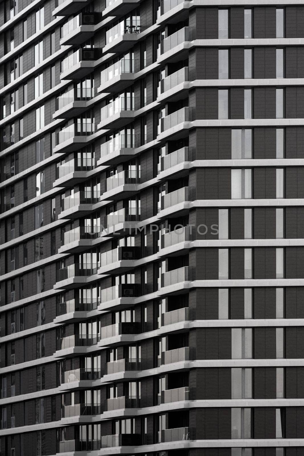 Building exterior of skyscraper, facade with balconies and windows, real estate business.
