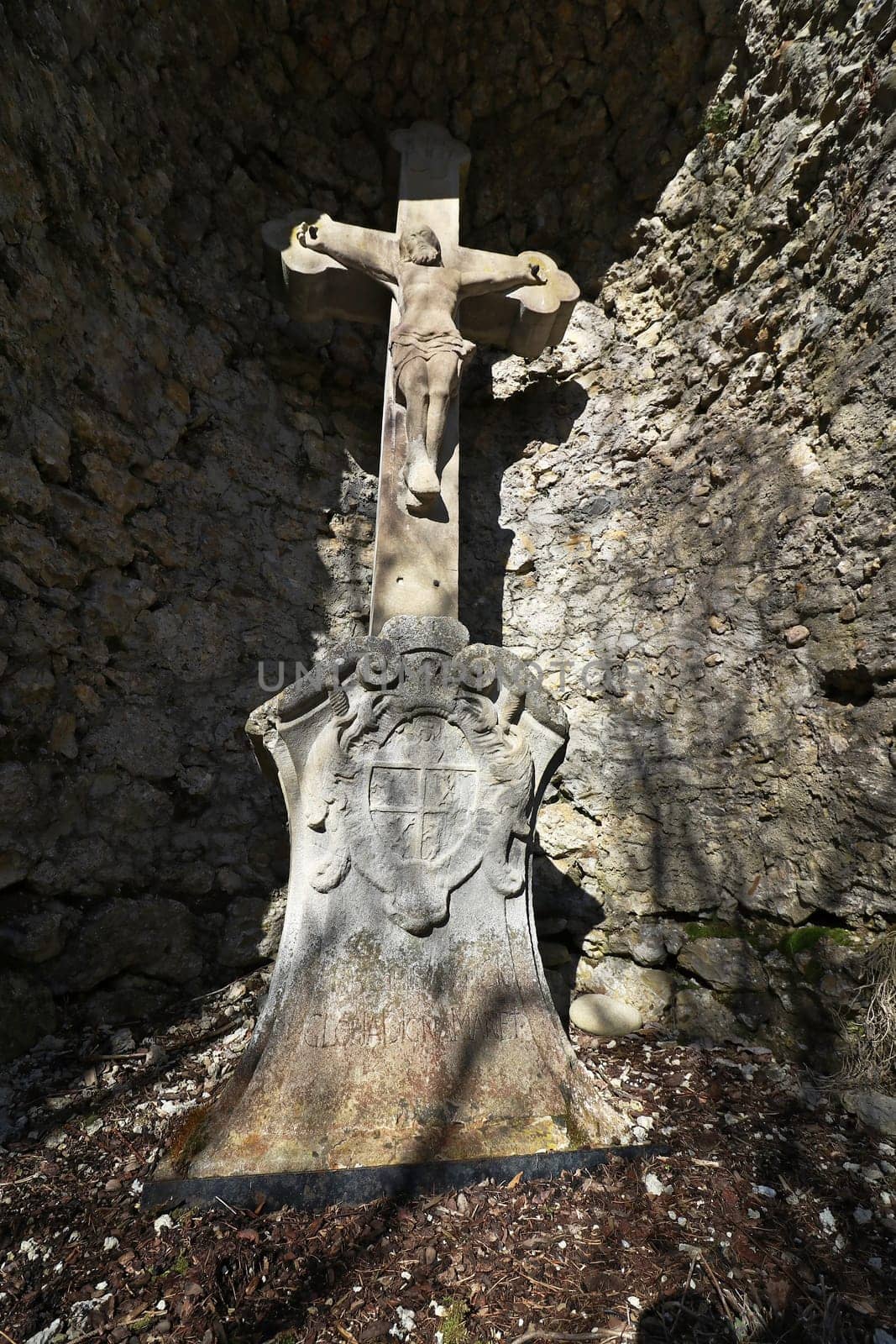 A stone cross in a cave. An old stone cross for pilgrims.