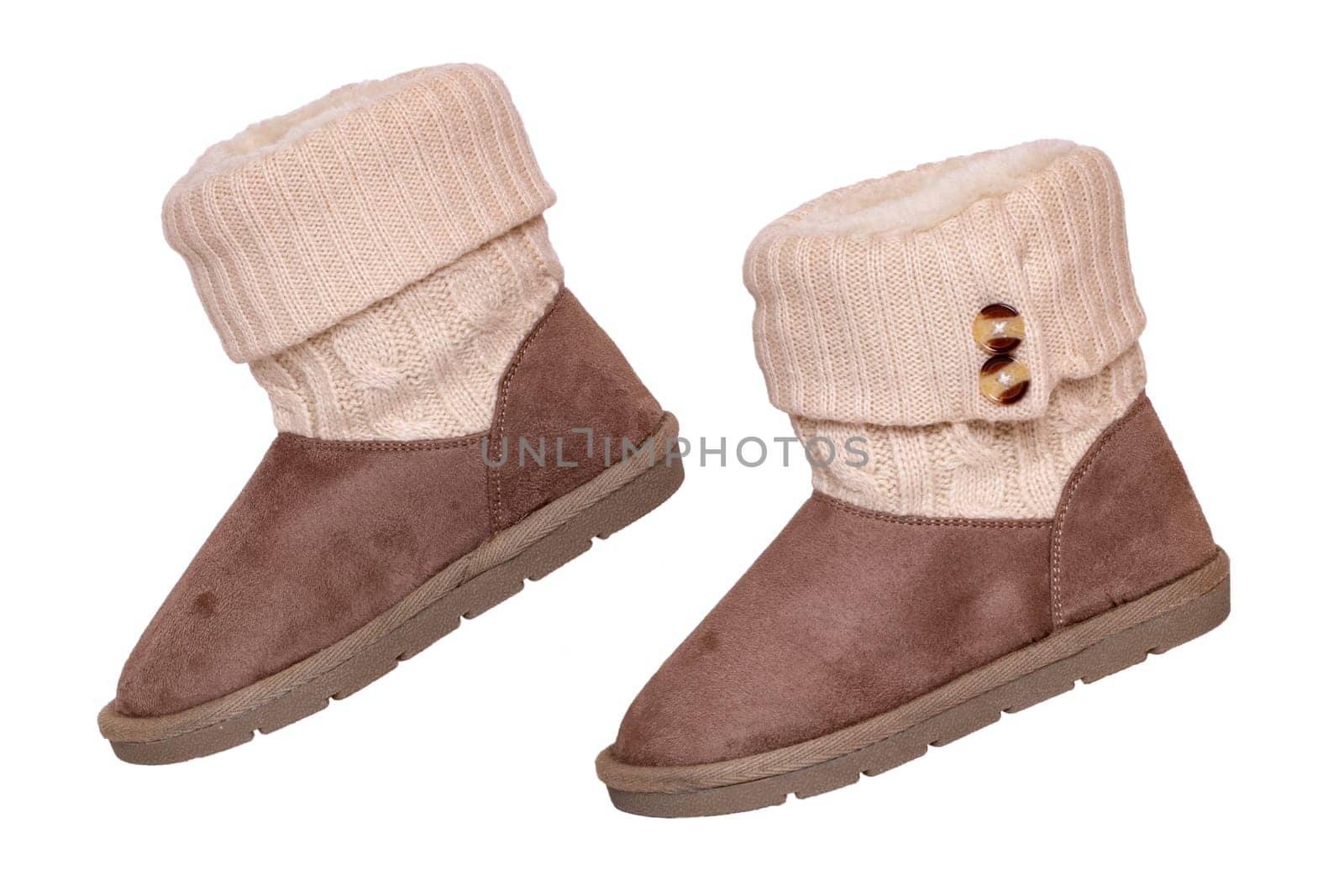 Winter boots. Close-up of a pair elegant brown suede leather winter boots with wool and lined with fur. Girls winter shoe fashion new collection. Isolated on a white background. Macro.
