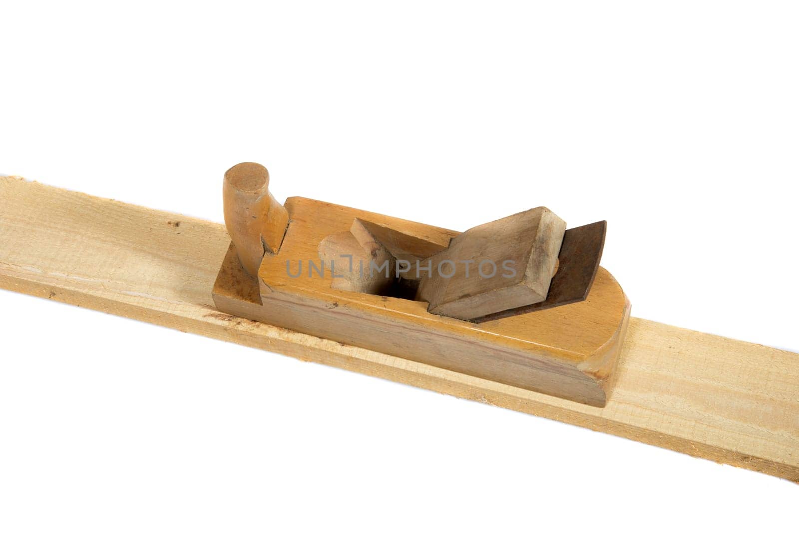 Old wooden hand planer or Carpenter Tool on wood plank isolated white background