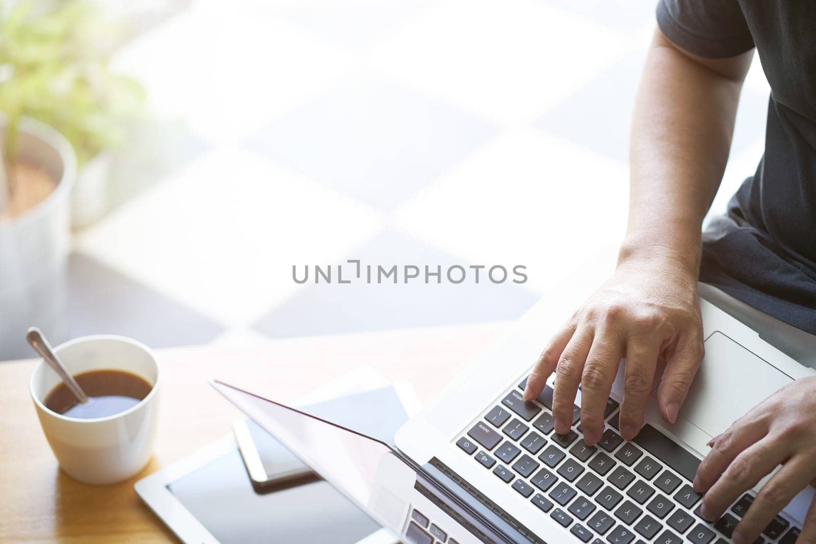 Laptop in businessman hand with digital tablet,smartphone and coffee .