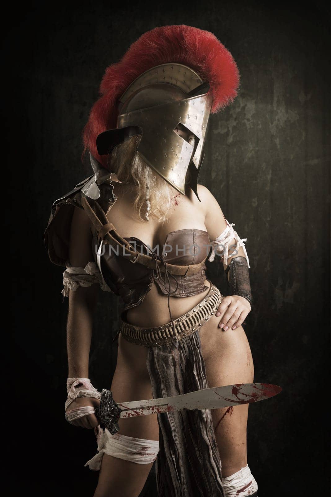 Ancient woman warrior or Gladiator posing in a dark background