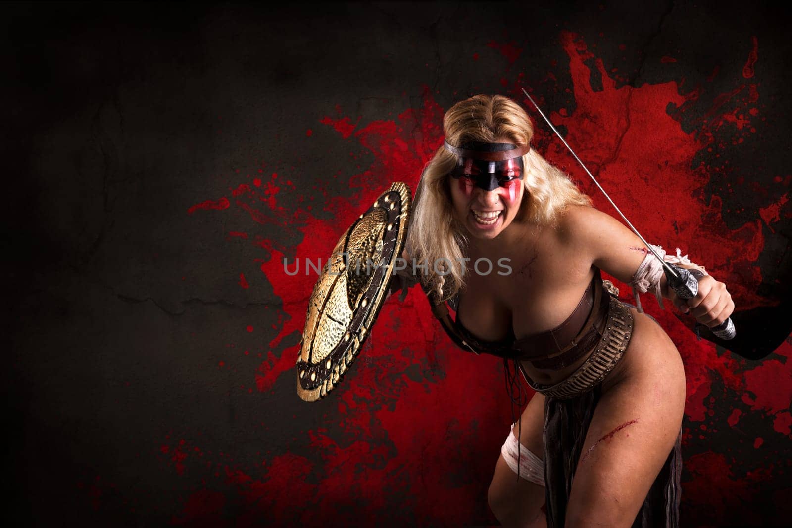 Ancient woman warrior or Gladiator posing in a dark background