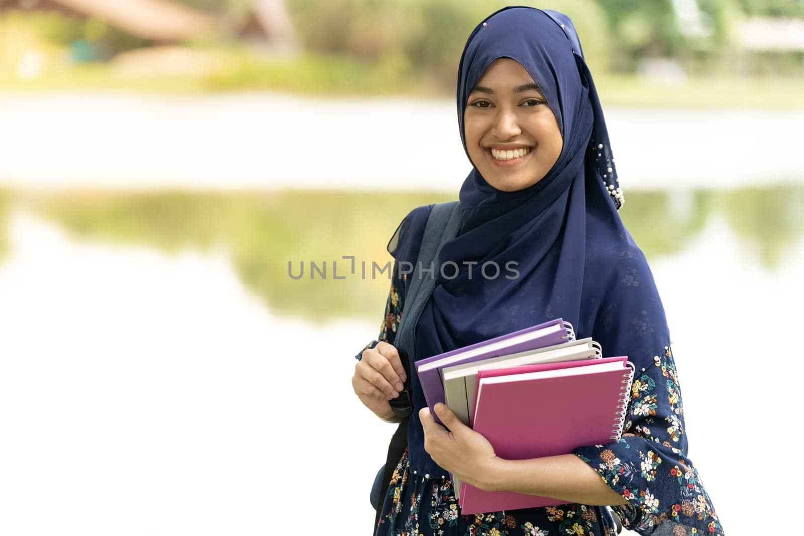Portrait of good-looking Happy young teenager Muslim islamic asian university girl