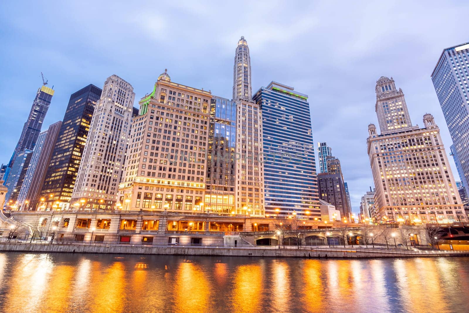 City of Chicago downtown and Chicago River sunset night in Chicago Illinois USA.