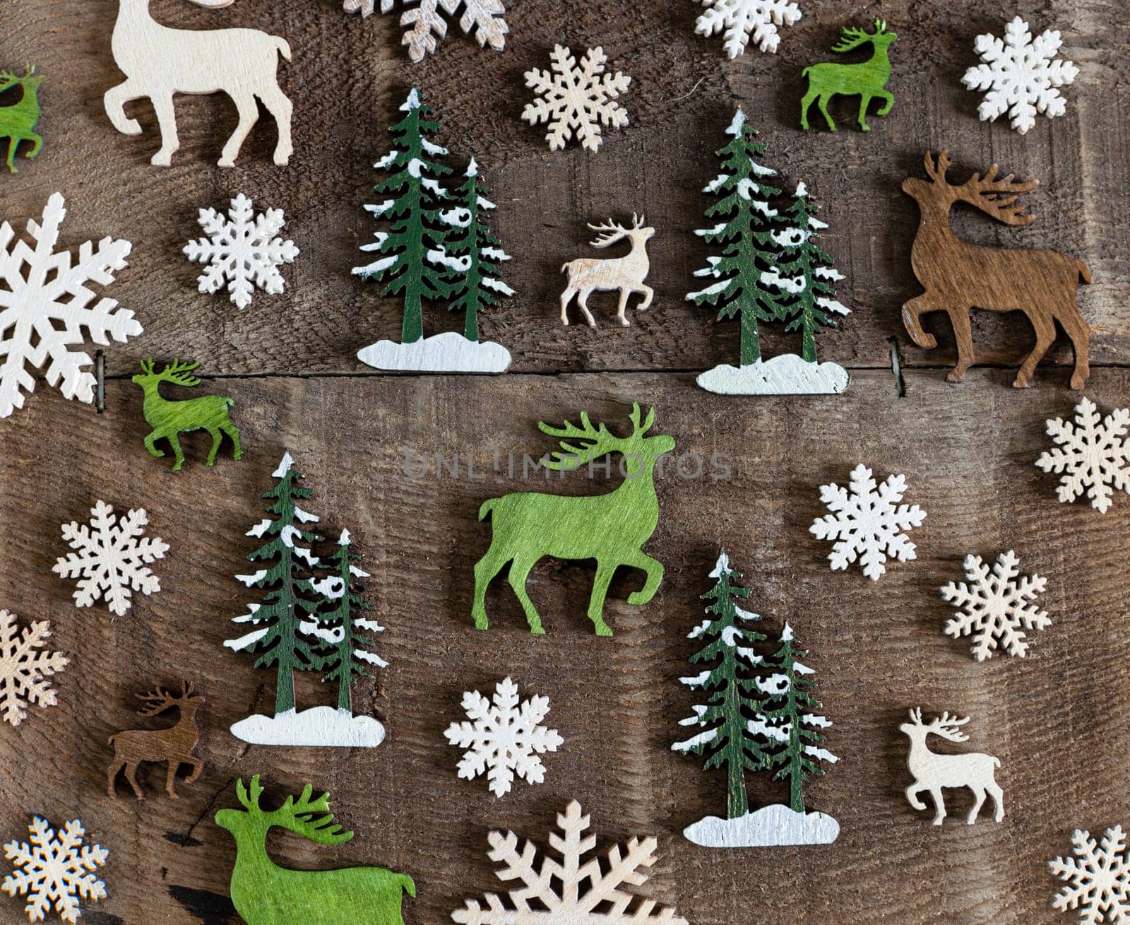 Rustic wooden background with little reindeer and trees