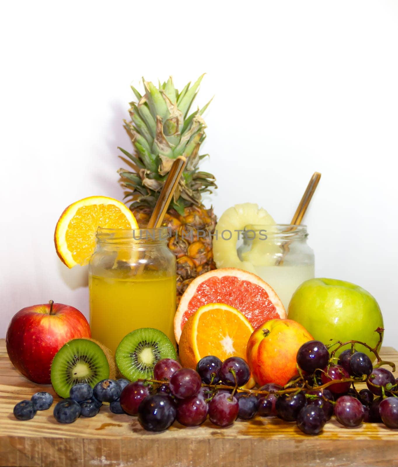 Juices smoothies and fresh pineapple and orange drinks with summer fruits