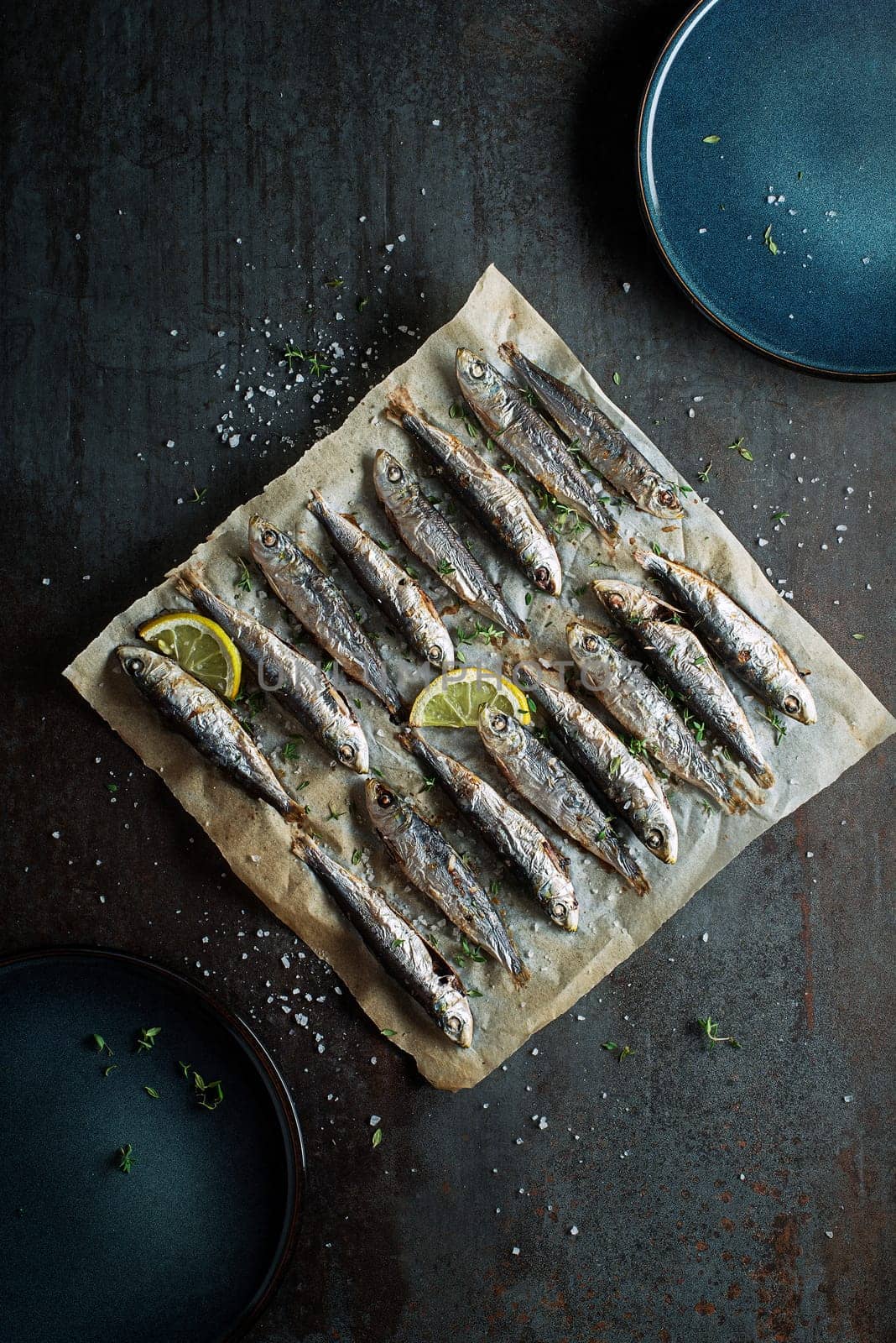 Grilled sardines with lemon and herbs close up. Healthy vegetarian fish meal