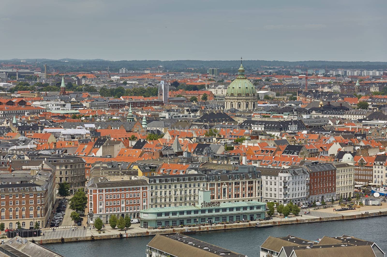 COPENHAGEN, DENMARK - JUNE 28, 2017: Skyline of scandinavian city of Copenhagen in Denmark during a cloudy day.