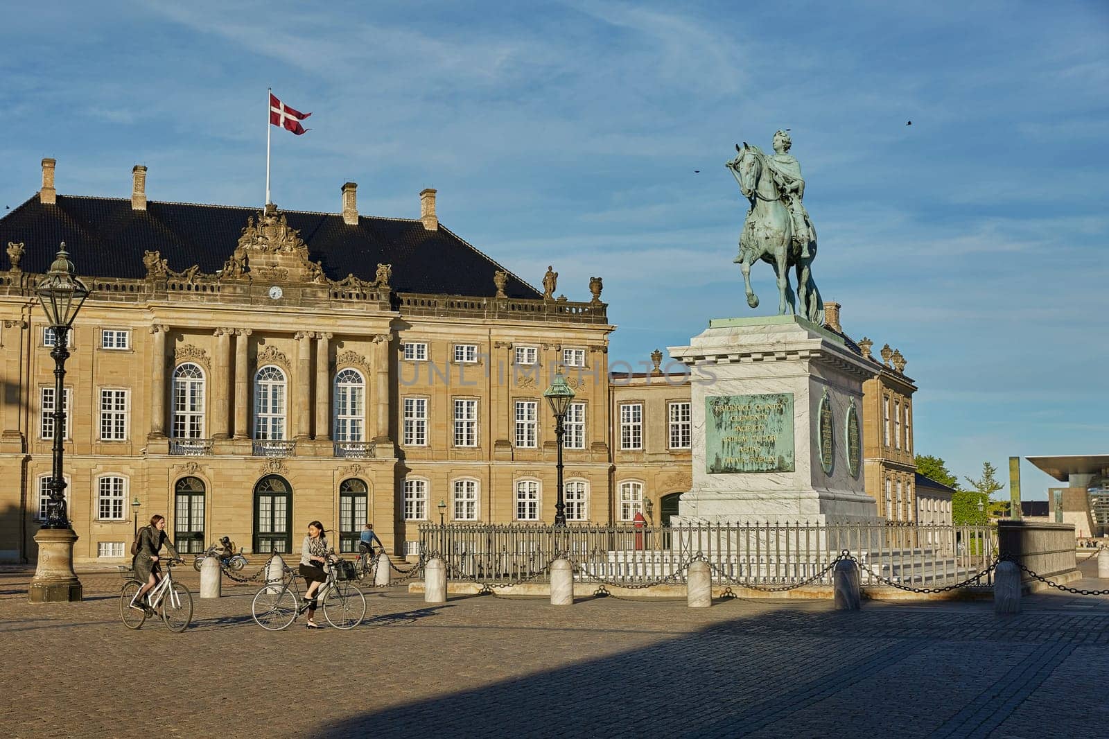 COPENHAGEN, DENMARK - MAY 25, 2017: Amalienborg is the residence of the Danish Royal Family. The palace is octagonal with a statue of King Frederik V in centre.