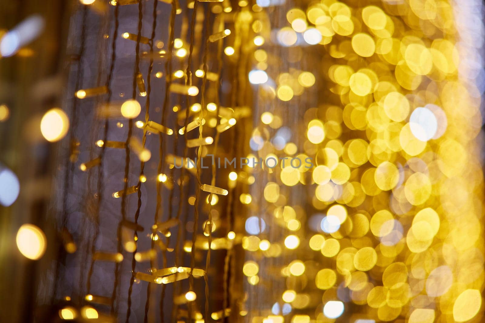 Festive background with LED lights garland. Christmas and New Year background. Blurred bokeh from the lights of a garland.