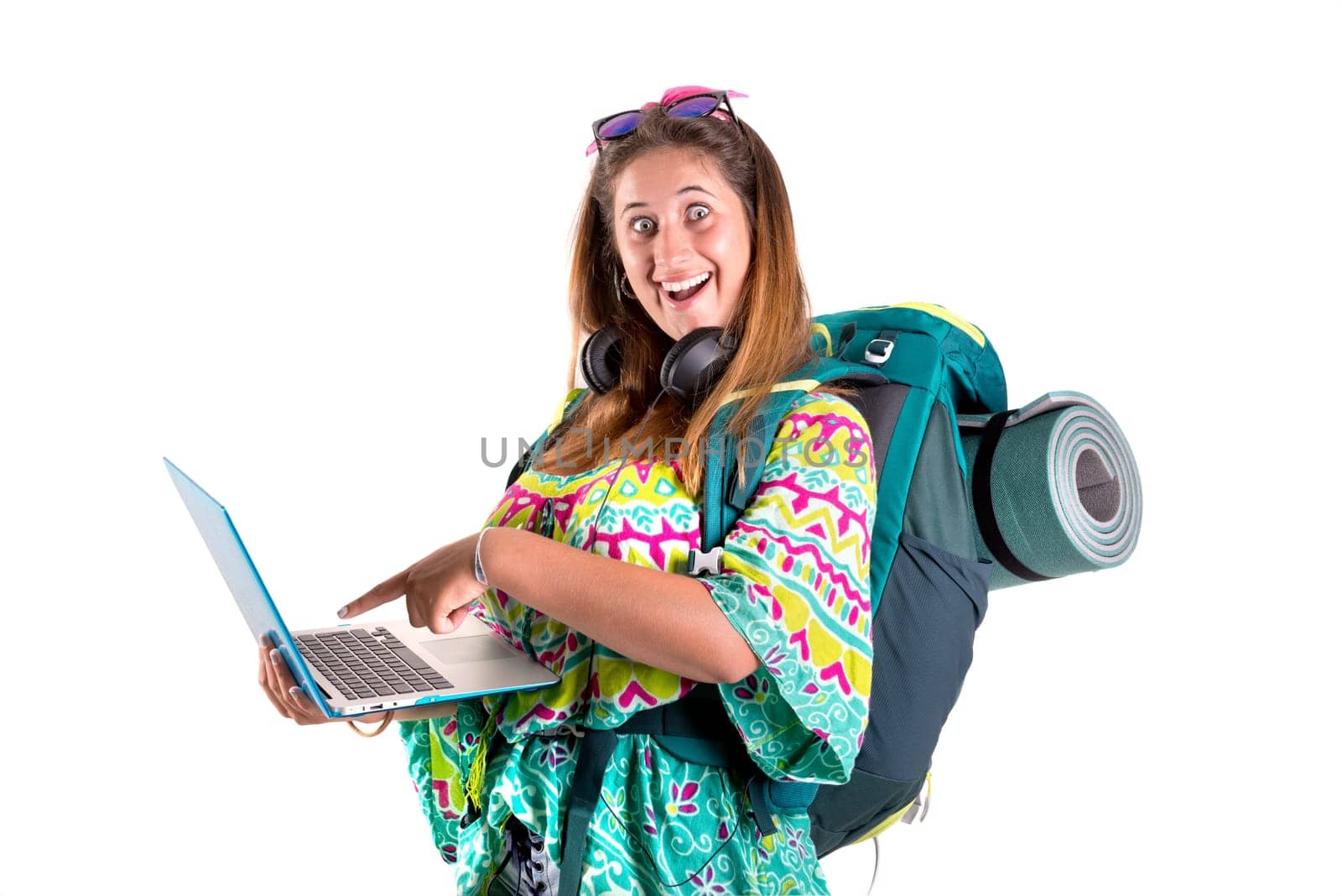 Happy hiker girl with backpack and laptop isolated in white, trekking and travel lifestyle concept