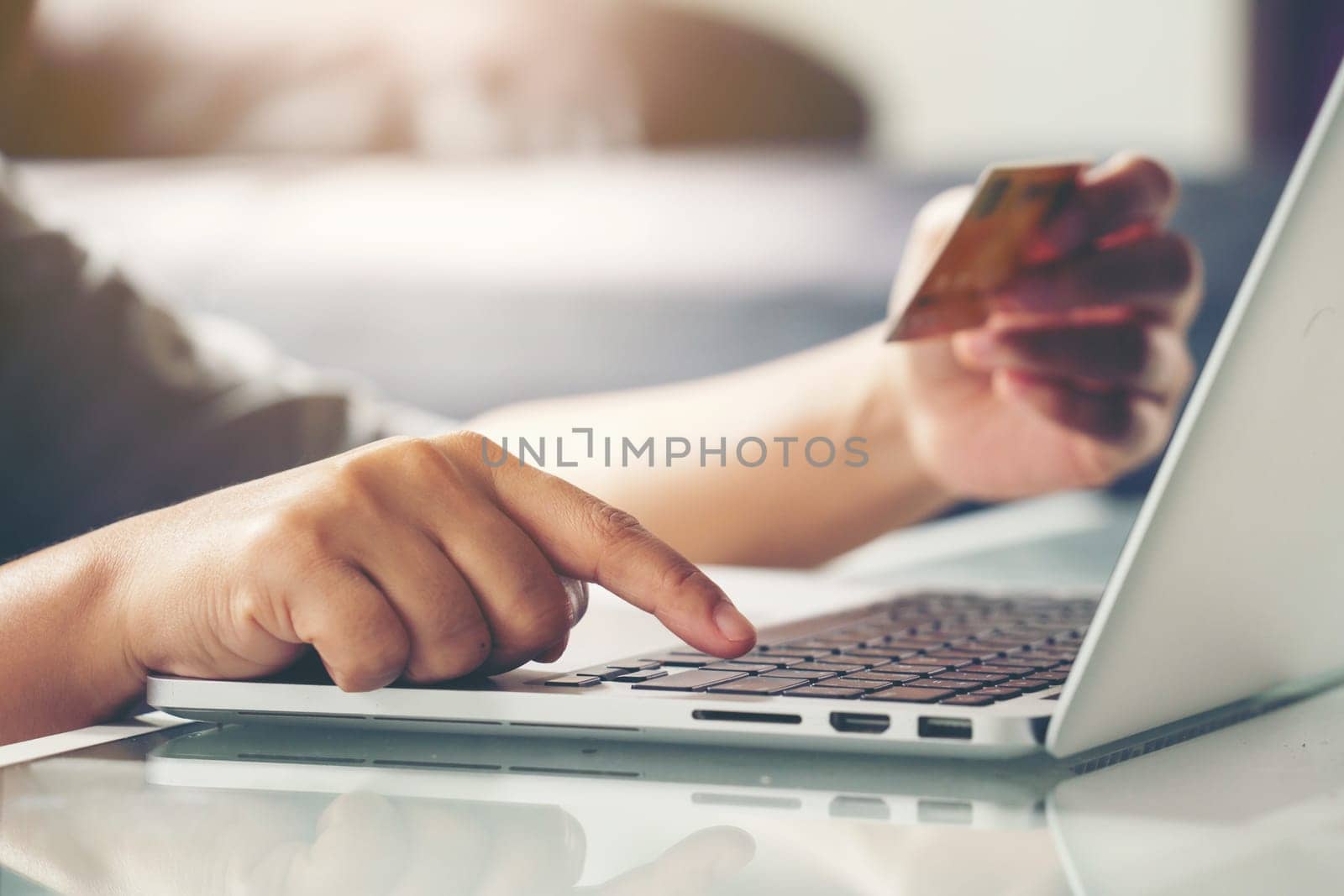 Women use credit card to shopping online at her home