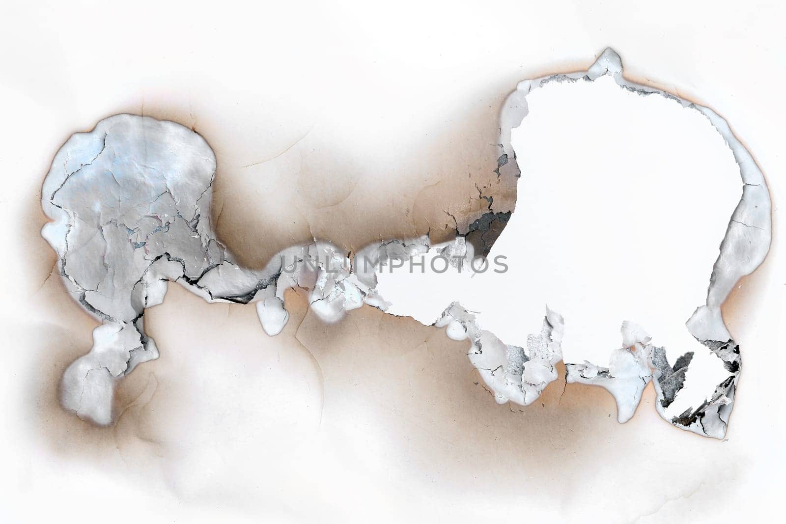 Detail of the burnt throughhole in a paper - charred edges