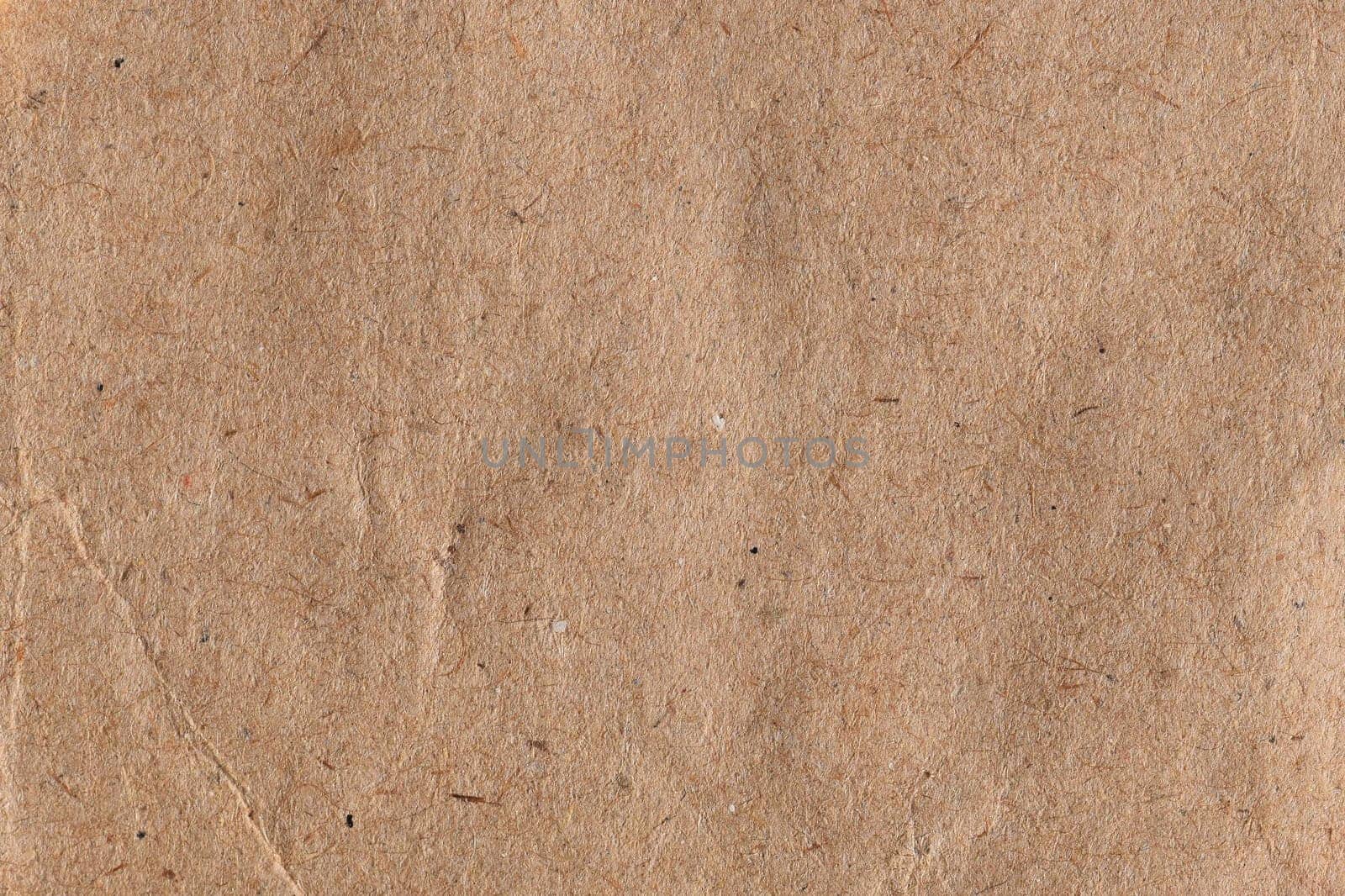 Brown paper with fibers and crease abstract background texture.