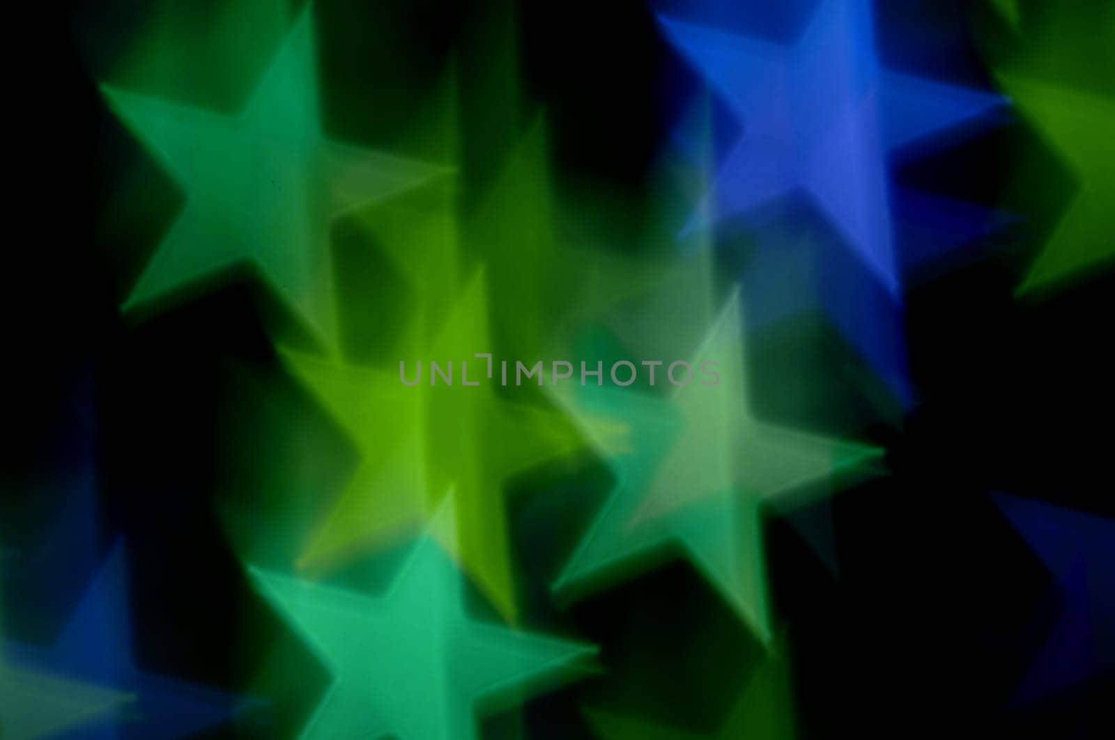 Blue and green stars bokeh abstract motion blur. Colorful background.
