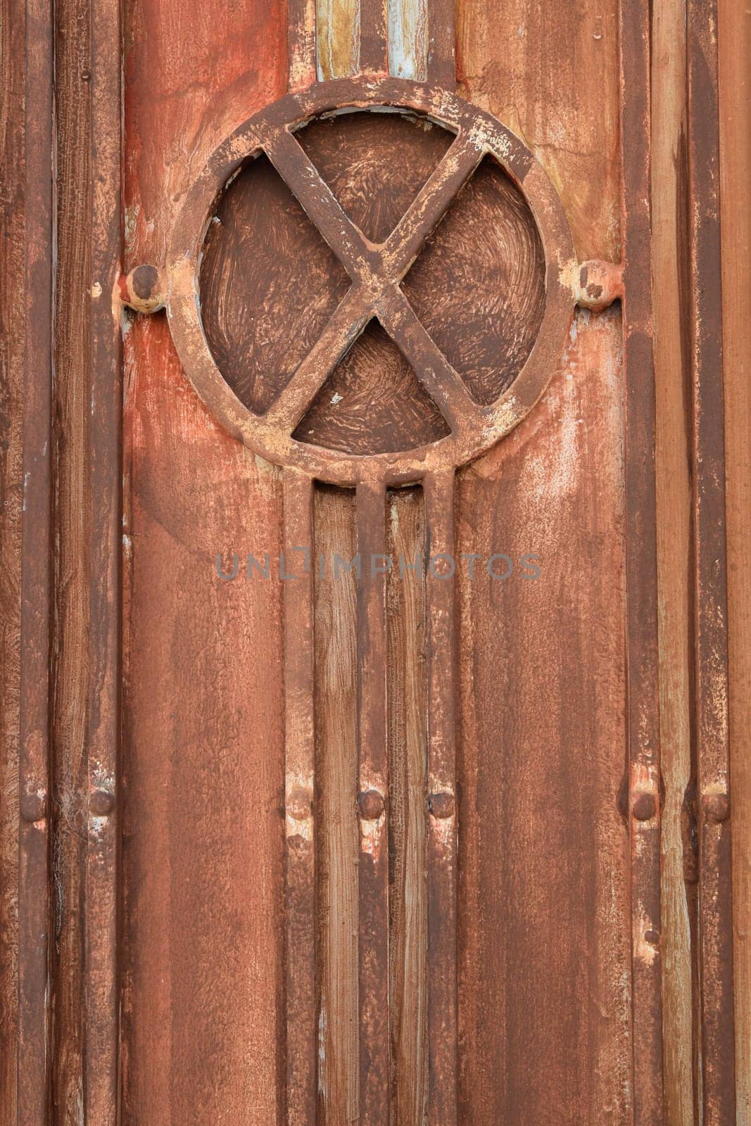 Vintage industrial metal gate detail with lines and circles pattern. Rusty background texture.