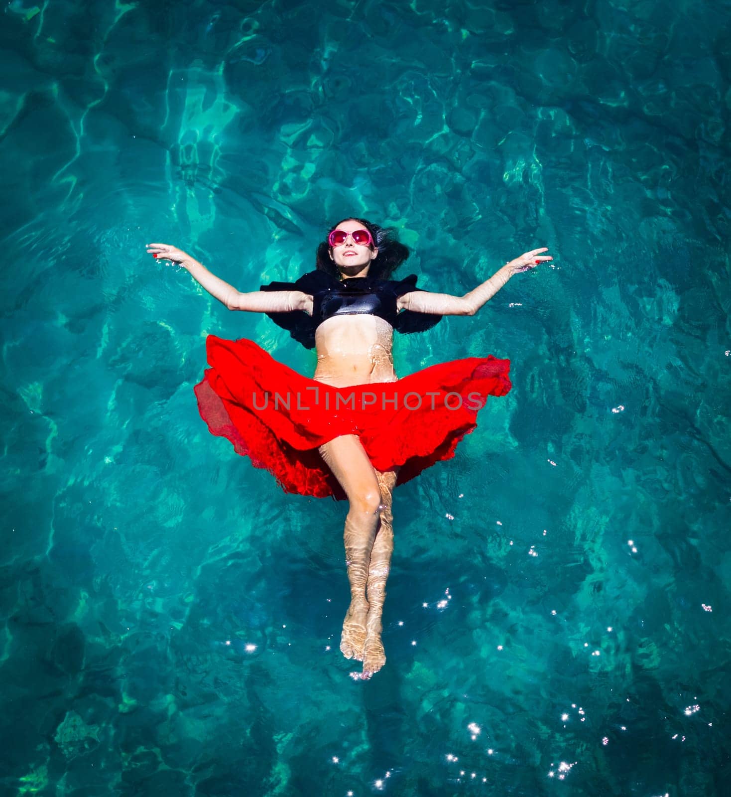 Aerial view of a beautiful woman dancing  in the sea