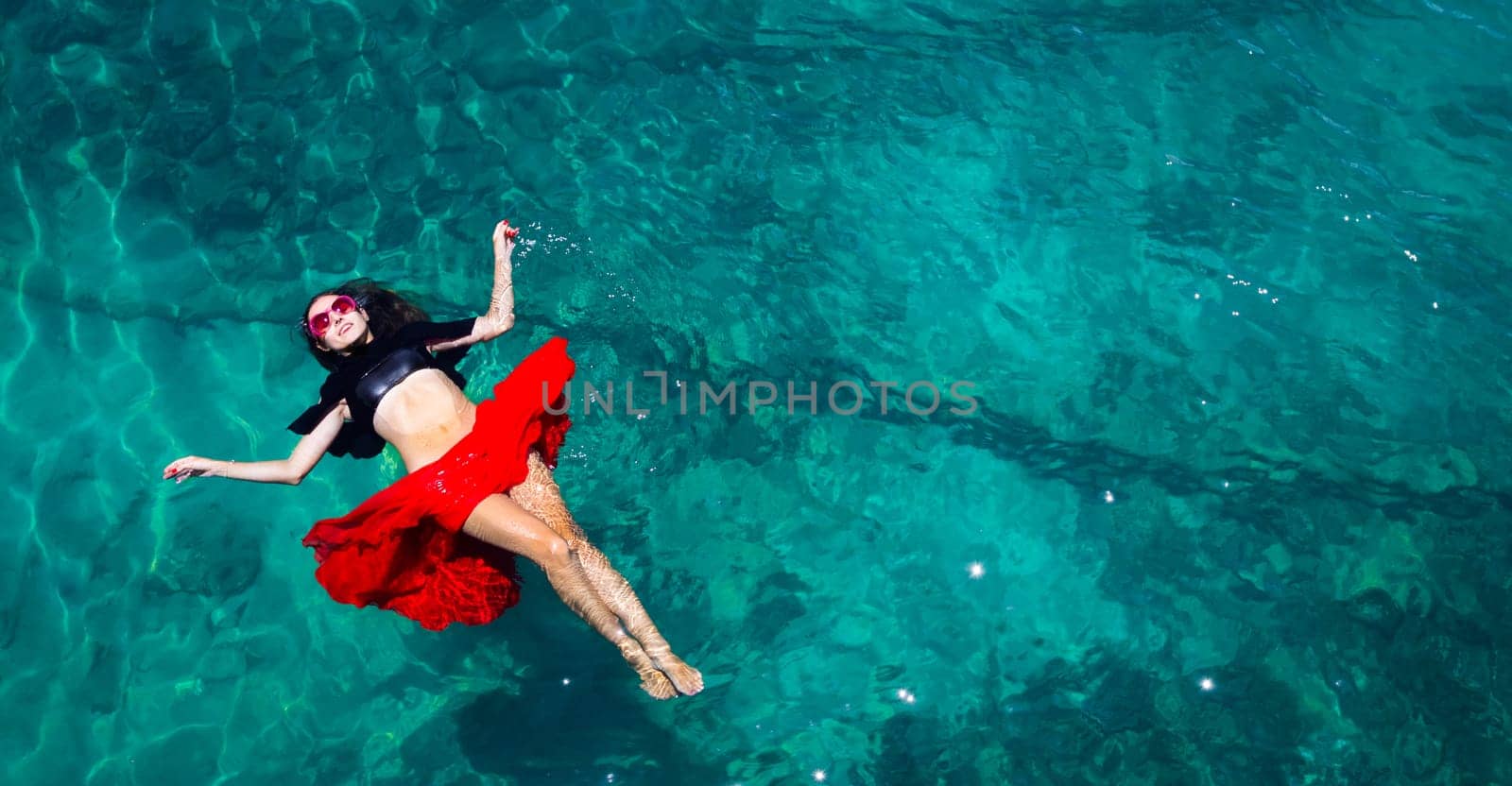 Aerial view of a beautiful woman dancing  in the sea