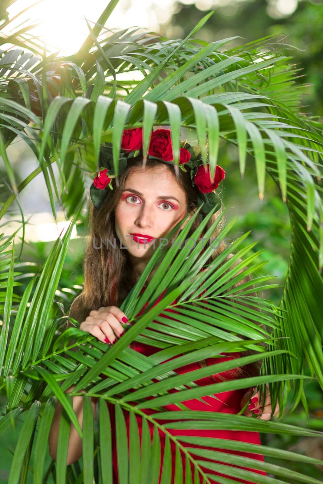 Fashion portrait of a beautiful woman in red dress outdoor