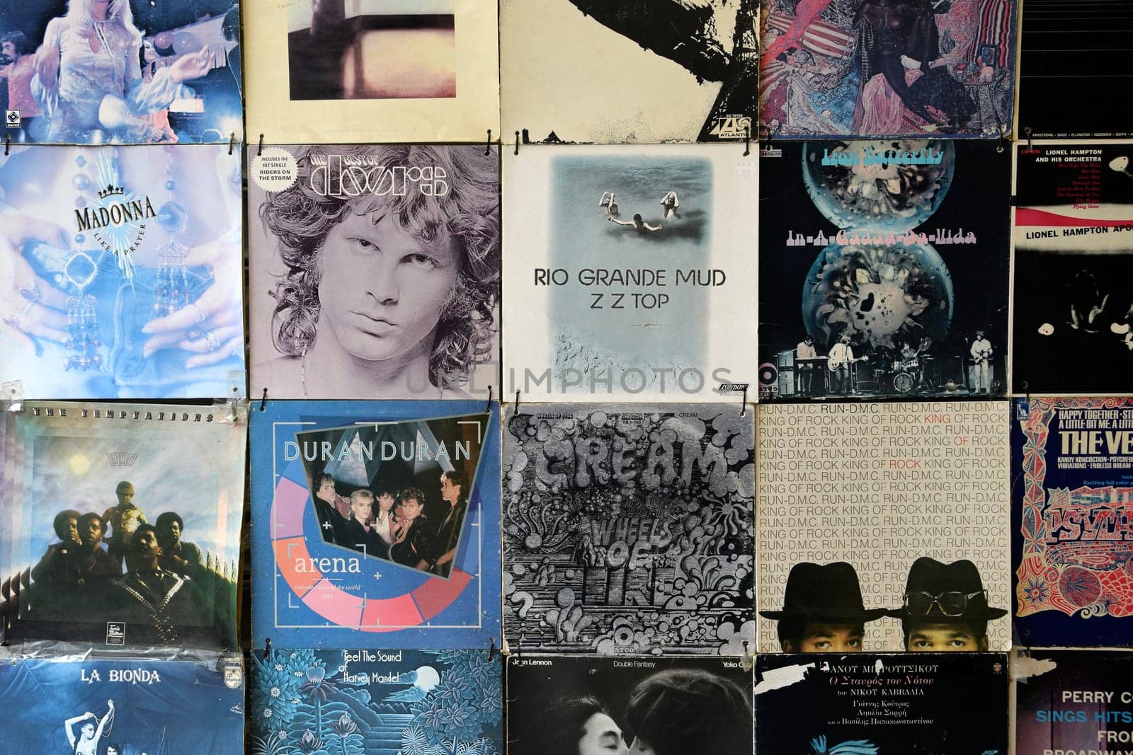 ATHENS, GREECE - APRIL 24, 2015: Old faded vinyl records pop and rock music vintage album sleeves background.