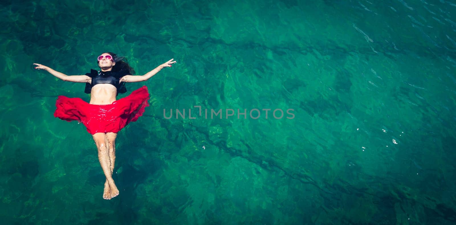 Aerial view of a beautiful woman dancing  in the sea