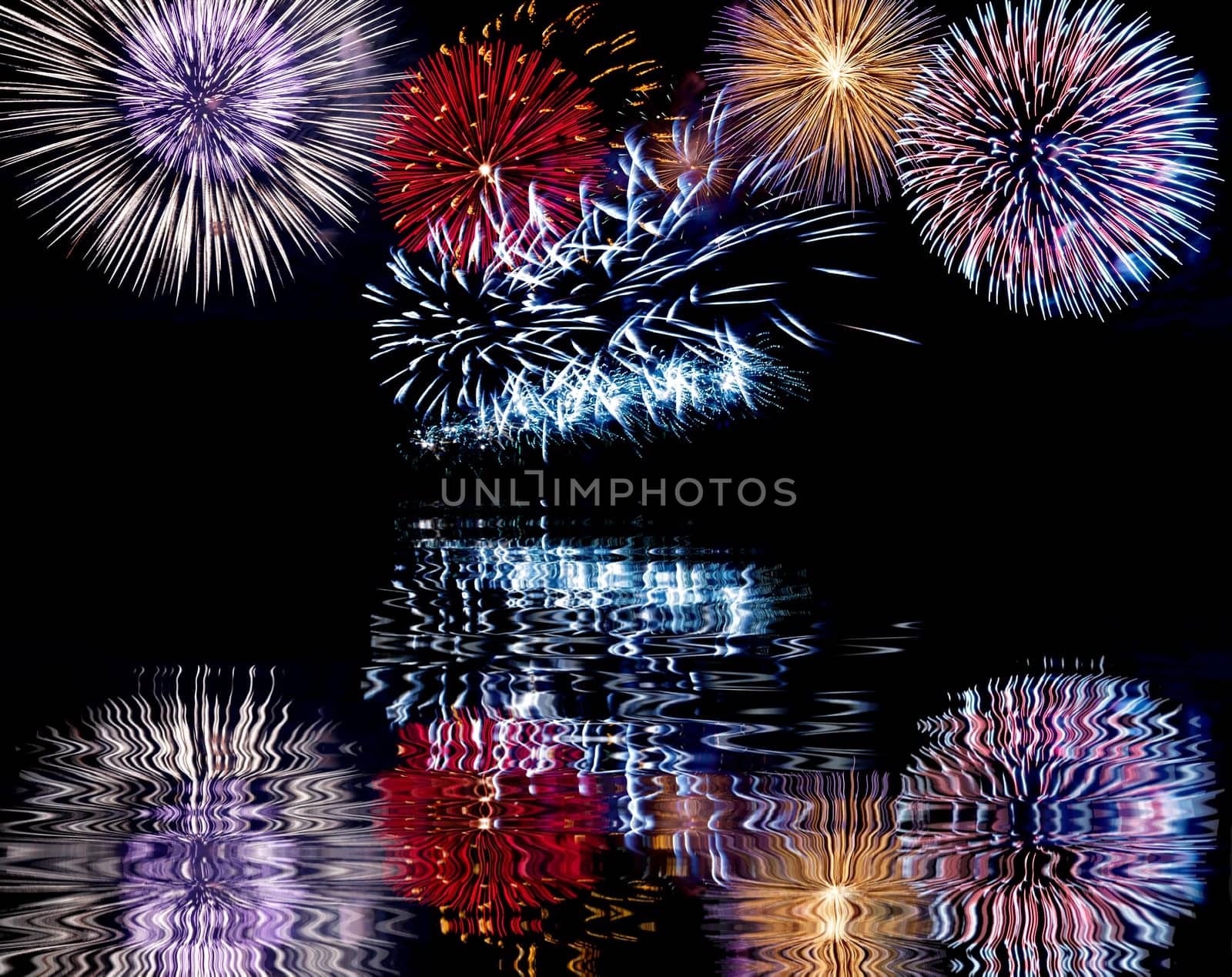 Blue, red and white colorful fireworks with reflection. Holiday celebration.